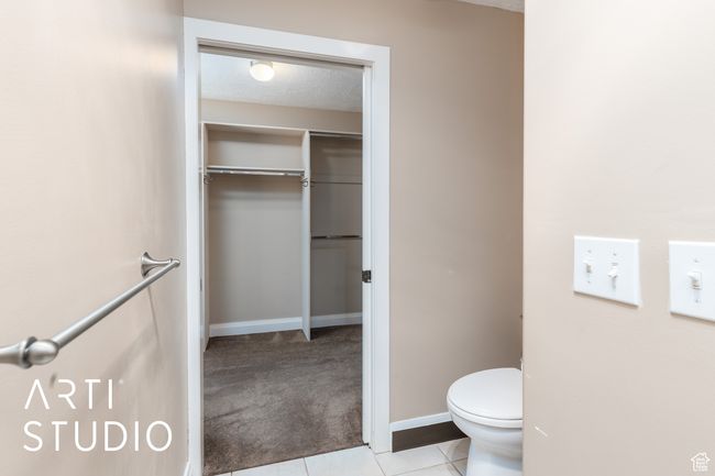 Bathroom featuring tile patterned floors, toilet, and baseboards | Image 28