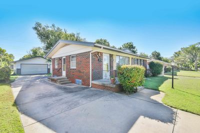 View of front of property featuring an outdoor structure, a garage, and a front yard | Image 3