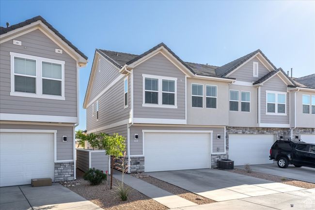 View of front of house with stone siding, an attached garage, and concrete driveway | Image 31