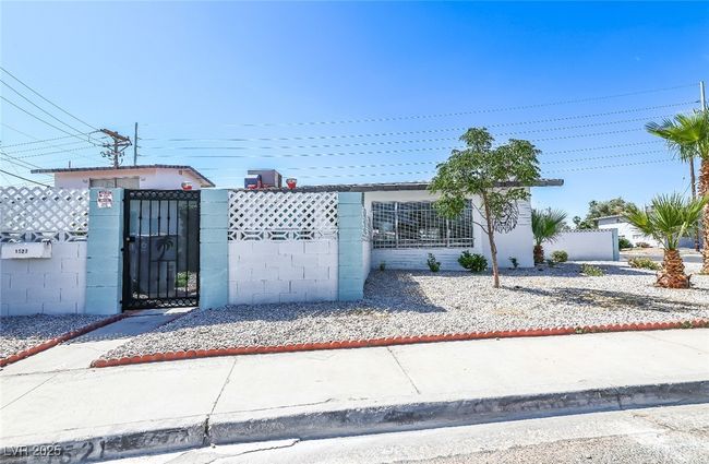 View of front of home with a fenced front yard and a gate | Image 4