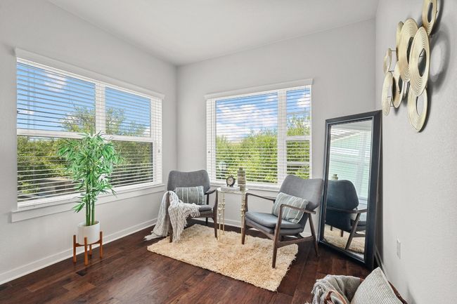 A cozy sitting area in the primary bedroom creates the perfect spot for reading or unwinding at the end of a busy day | Image 24