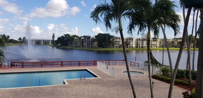 ClubHouse Pool Overlooking Lake And Water Fountain | Image 30