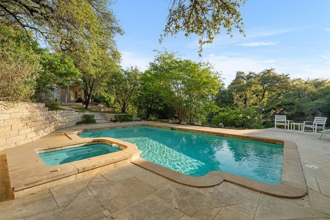 View of swimming pool with a patio and a pool with connected hot tub | Image 35