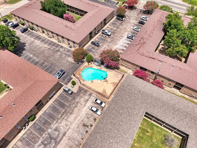 View of asphalt street featuring a gate, a gated entry, and curbs | Image 20