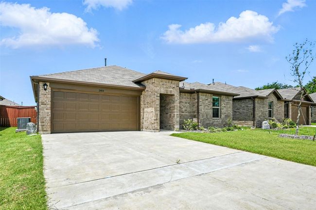 View of front facade featuring brick siding, driveway, a garage, and roof with shingles | Image 22