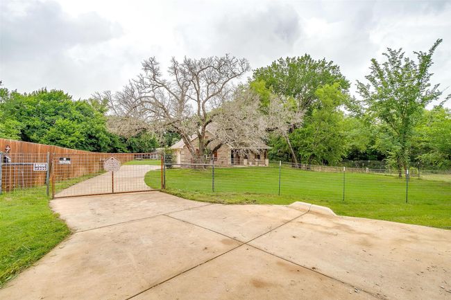 Fenced front yard featuring a gate | Image 4
