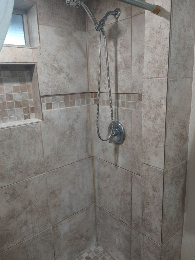 Bathroom view of a tile shower | Image 6