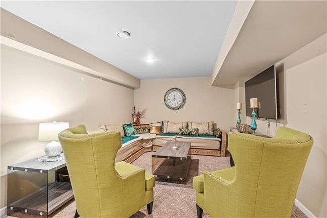 Carpeted living area with baseboards | Image 28