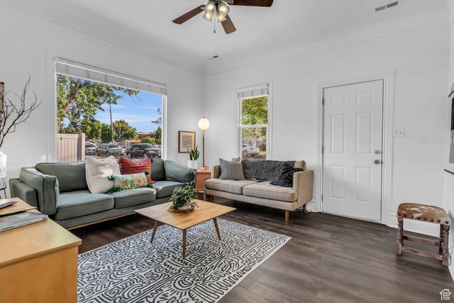 Living room with a ceiling fan and wood finished floors | Image 4