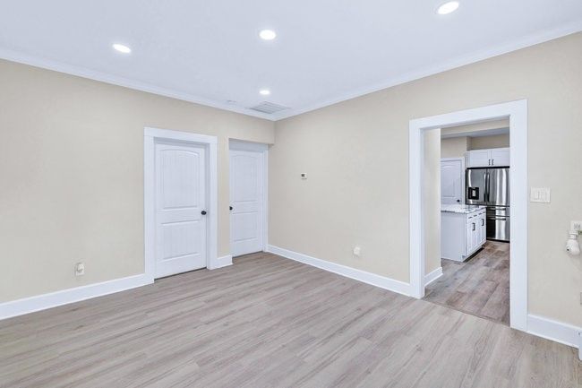 Unfurnished room featuring ornamental molding, recessed lighting, baseboards, and light wood-type flooring | Image 8