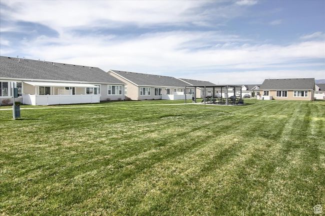Rear view of house with a residential view, fence, and a lawn | Image 24