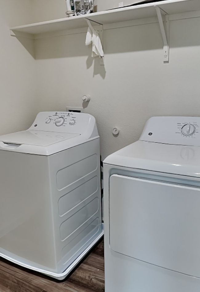 Laundry room with wood finished floors and washer and dryer | Image 33