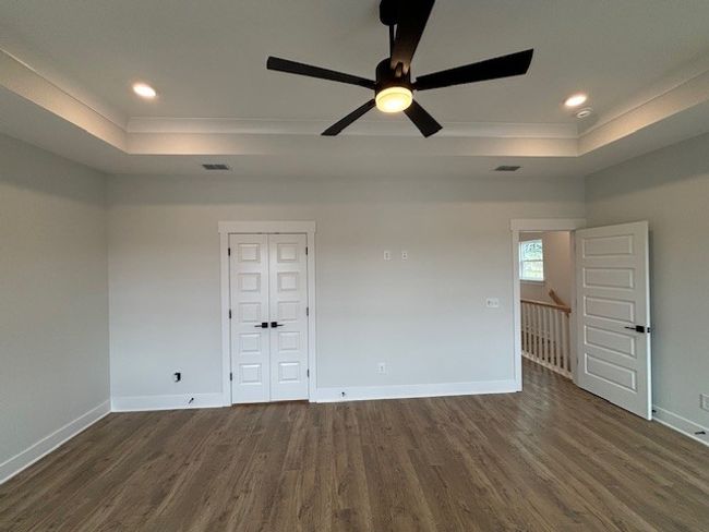 Spacious primary bedroom with tray ceiling and ceiling fan!! | Image 23