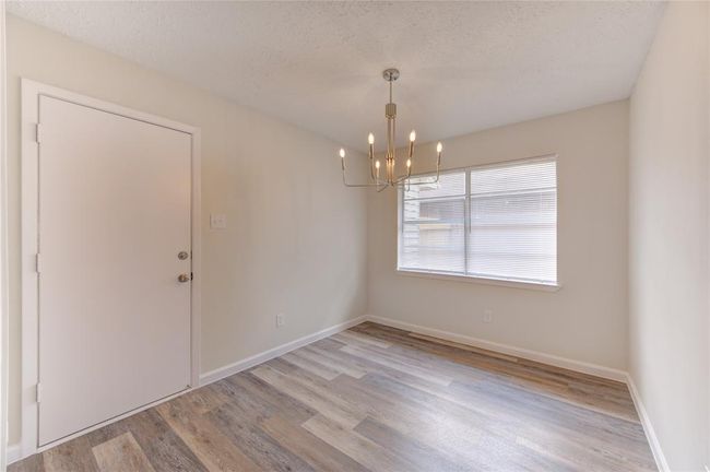 Breakfast Area has new chandelier and garage access. | Image 12