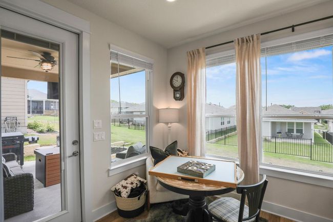 Dining space with wood finished floors, baseboards, and ceiling fan | Image 29