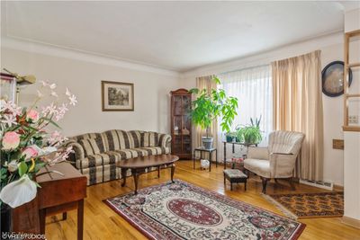 Hardwood floors, and coved plastered ceilings plus the window treatments stay. | Image 2