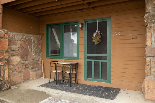 View of exterior entry with stone siding | Image 17