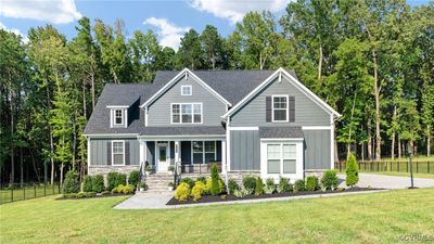 Craftsman-style home featuring a front lawn and covered porch | Image 1