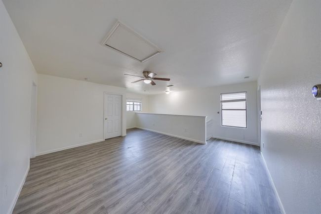 Warm light streams through windows, brightening the game room and stairs with a cozy, inviting glow. | Image 20