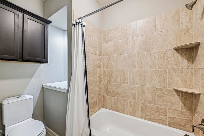 Full bath featuring shower / bath combination with curtain and toilet | Image 30