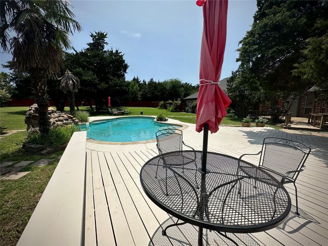 Swimming pool featuring a lawn, a patio, and a deck | Image 29