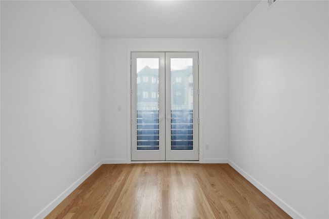Spare room featuring french doors, light wood-style flooring, and baseboards | Image 14