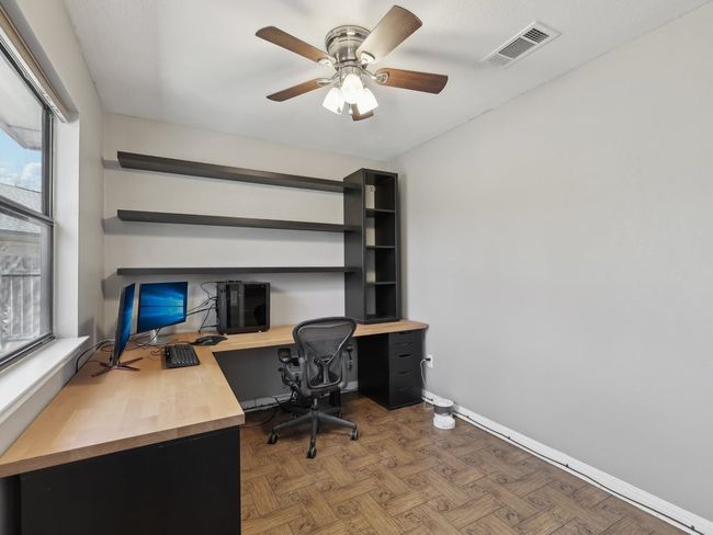 Office area with visible vents, baseboards, and a ceiling fan | Image 19