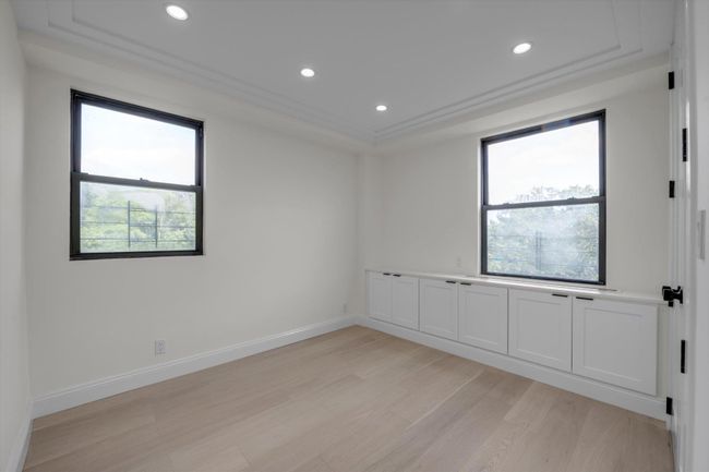 Spare room with light wood-style floors, plenty of natural light, recessed lighting, and a raised ceiling | Image 10