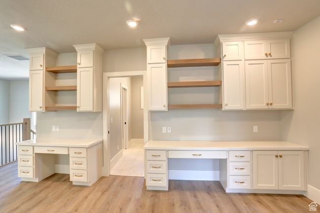 Unfurnished office with built in desk, light wood-type flooring, and recessed lighting | Image 20