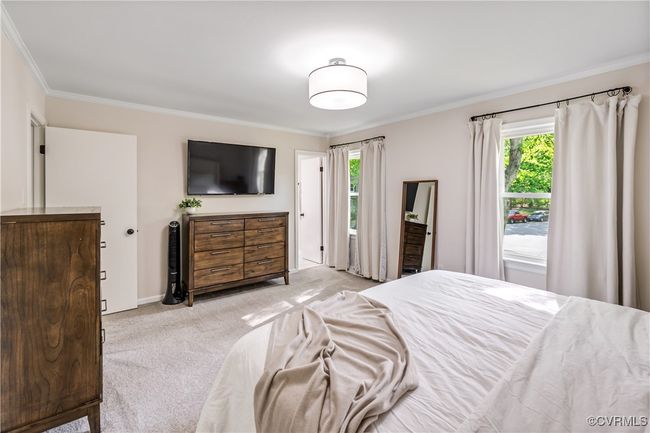 Carpeted bedroom featuring ornamental molding, multiple windows, and baseboards | Image 20