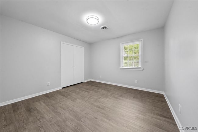 Empty room featuring wood finished floors, visible vents, and baseboards | Image 21