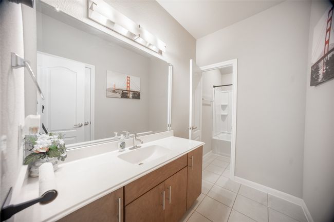 Bathroom featuring tile patterned floors, bathtub / shower combination, and vanity | Image 23