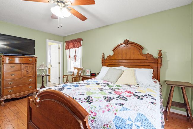 Bedroom with light wood-style floors and a ceiling fan | Image 12