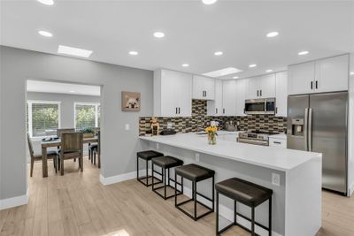 Spacious, modern kitchen with large quartz counter | Image 1