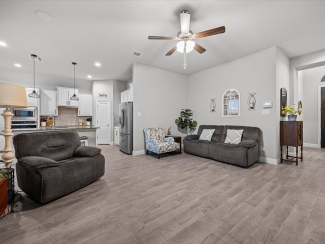 Living area with a ceiling fan, recessed lighting, and light wood-style floors | Image 13