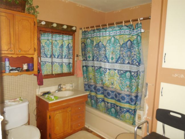 Full bath with toilet, shower / bath combination with curtain, and vanity | Image 6