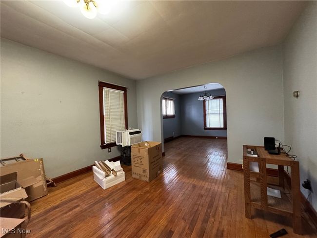 Living room with baseboards, cooling unit, arched walkways, and hardwood / wood-style floors | Image 11