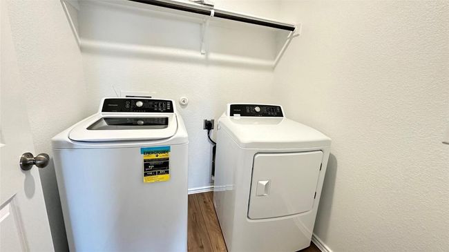 Laundry area featuring laundry area, dark wood-type flooring, and washer and clothes dryer | Image 16