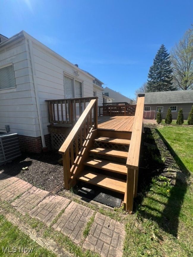 Wooden deck featuring central AC unit and a lawn | Image 35