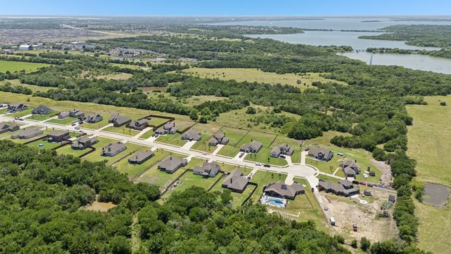 Aerial overview of property's location with a large body of water and a forest | Image 25