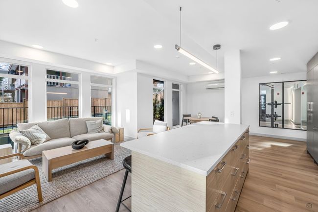 Interior space featuring recessed lighting, light wood-type flooring, baseboards, and a wall unit AC | Image 28