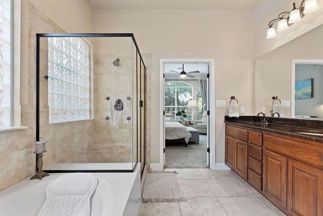 Choose to bathe in either the soaking tub or glass-encased walk-in shower. | Image 22