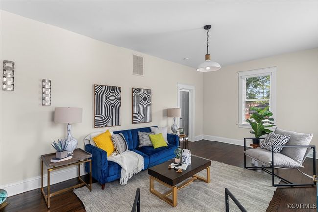Living room featuring wood finished floors, visible vents, and baseboards | Image 10