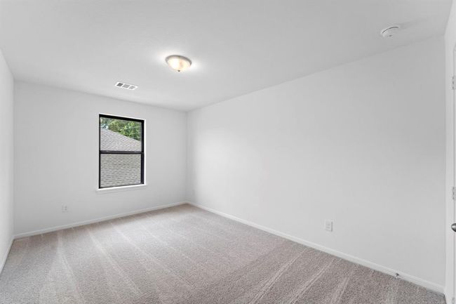 Your secondary bedroom features plush carpet, fresh paint, closet, and a large window that lets in plenty of natural lighting. | Image 19