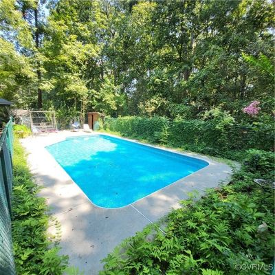 View of swimming pool with a patio area | Image 3