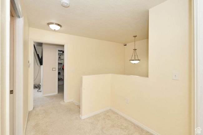 Corridor with light colored carpet and baseboards | Image 29