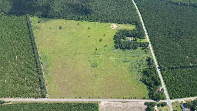 Aerial view of property and surrounding area with property parcel outlined and rural landscape | Image 8