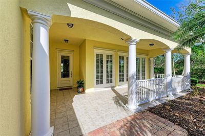 Charming front porch is perfect for a morning cup of coffee as you enjoy the scenery. | Image 3