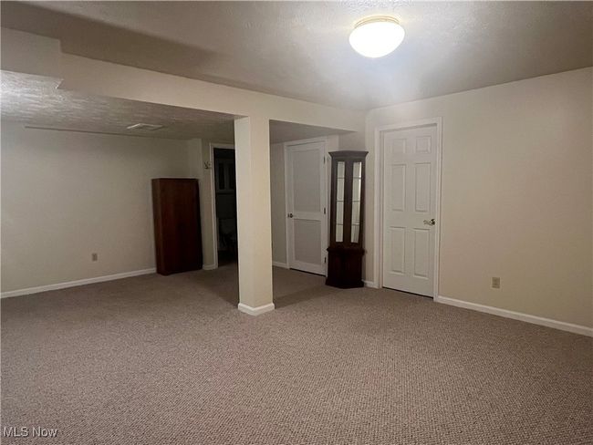 Another view of the finished Basement. Behind one door is the 3rd Bathroom. Behind the second door is the Hot Water Tank and Furnace. And, behind the third door is the crawl space. | Image 23