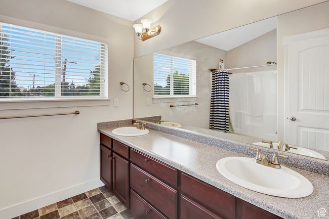 Full bathroom with double vanity and a shower with curtain | Image 20